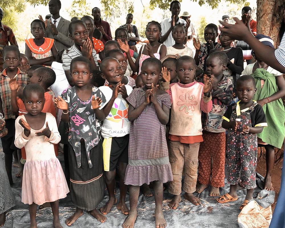 A group of African children are led in praises in Uganda.